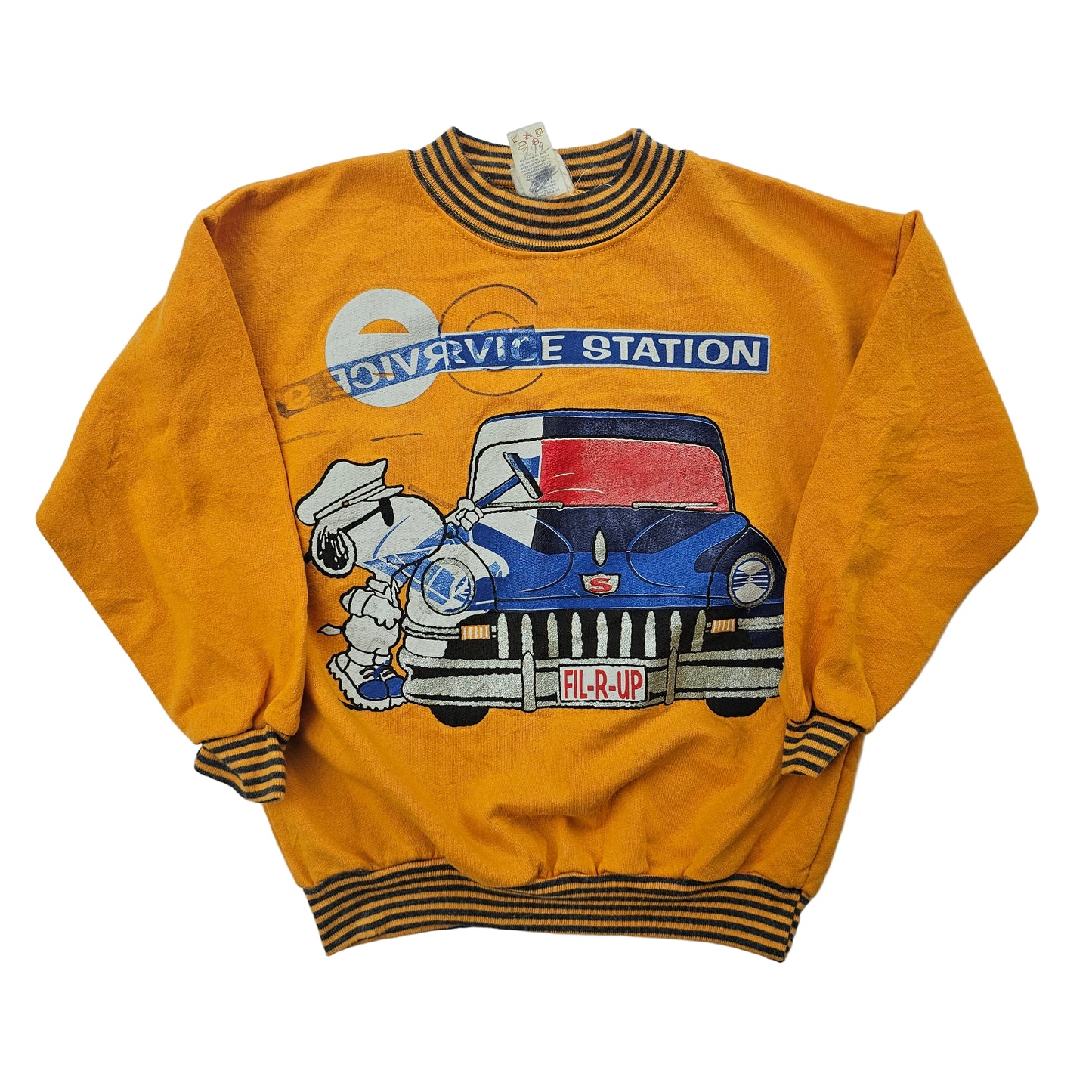 A vintage Peanuts Snoopy sweatshirt with a graphic of Snoopy working at a service station, wearing a gas station attendant uniform, and a car with the text 'Fill-R-Up'. The shirt is yellow with a striped collar and the print has silver glitter detail.